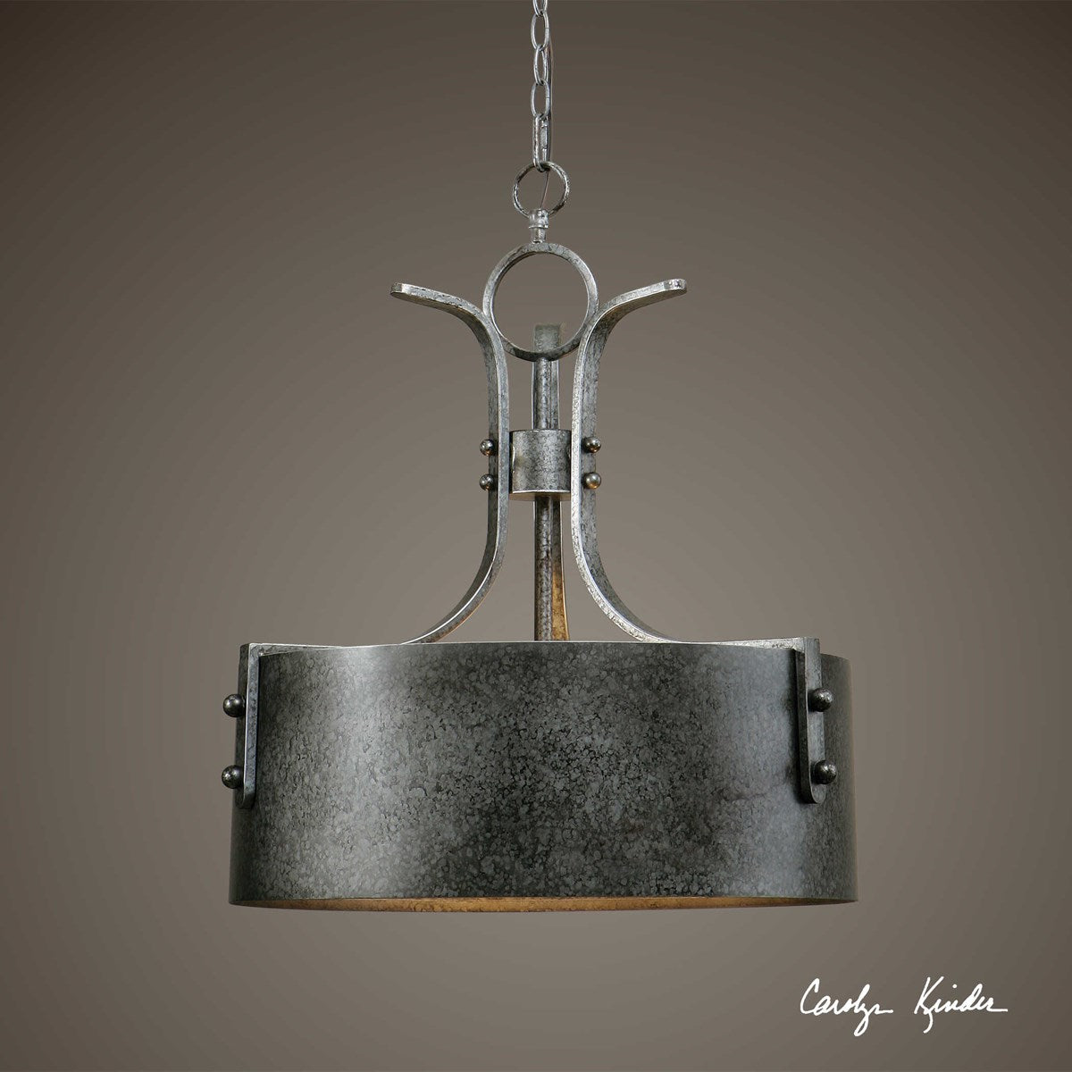 Leland 3 Light metal drum pendant. Masculine Lines and the Beauty of Architectural details are the strength of this pendant. Antiqued silver with warm rust distressing, both inside and out, add depth to the metal finish. A bold statement of today's transitional looks.