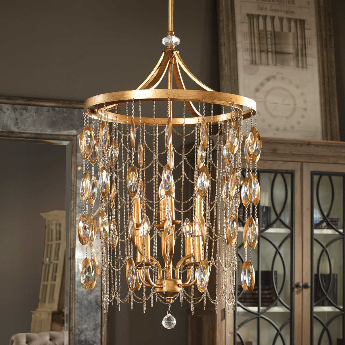 Soft draping of metal strands gives an almost fabric curtain feel to this 8 light chandelier. This exquisite chandelier features an antique gold leaf finish accented with antiqued nickel chains and clear crystals which move.