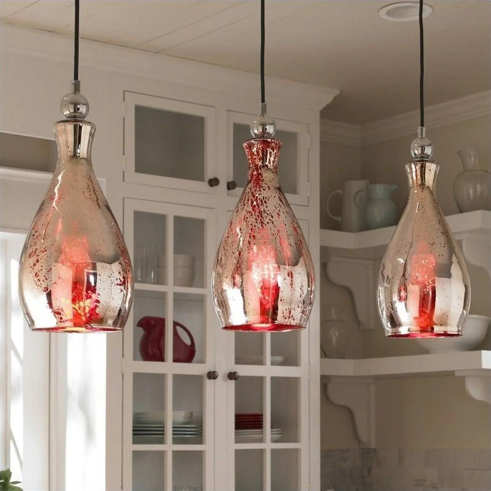 Uttermost Sardinia 21985 Mini Pendant Light. This curved pendant light offers a rich red hue for a touch of sophistication. Red Mercury Glass With Plated Chrome Accents.